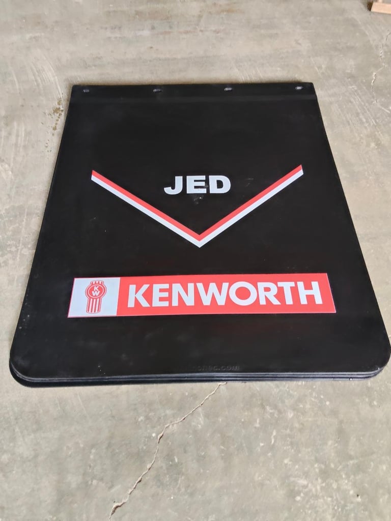 Black rubber mudflap with JED and KENWORTH branding featuring red and white chevron design
