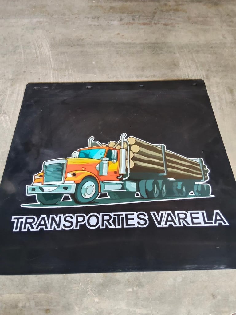 Logo for Transportes Varela featuring an illustrated orange and teal truck loaded with wooden logs on a black background